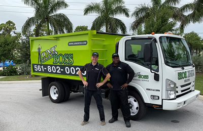 Junk Boss employees posing beside the truck