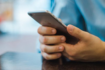 Man sitting down with phone in hand