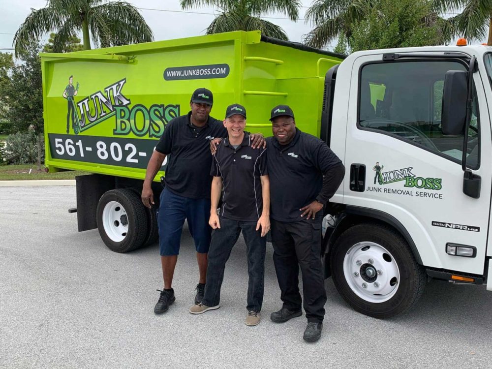 Junk Boss team beside the truck